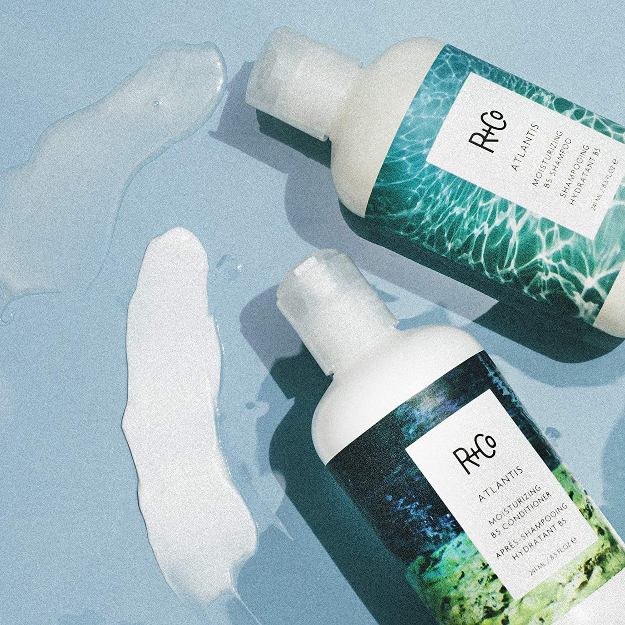 R+Co Atlantis bottles stacked on counter for home spa hydration routine