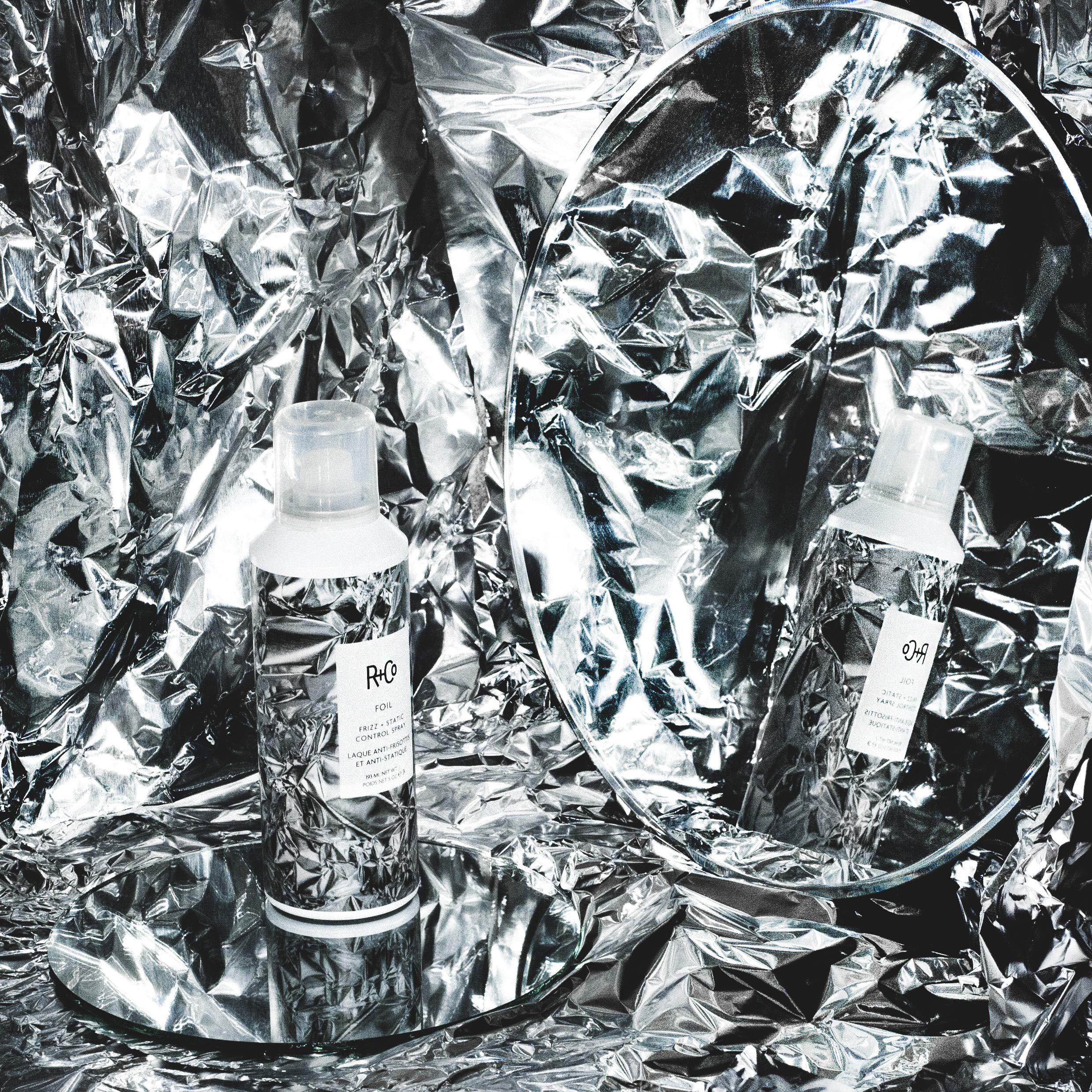 R+Co Foil Frizz Spray closeup highlights lightweight formula and flyaway reduction