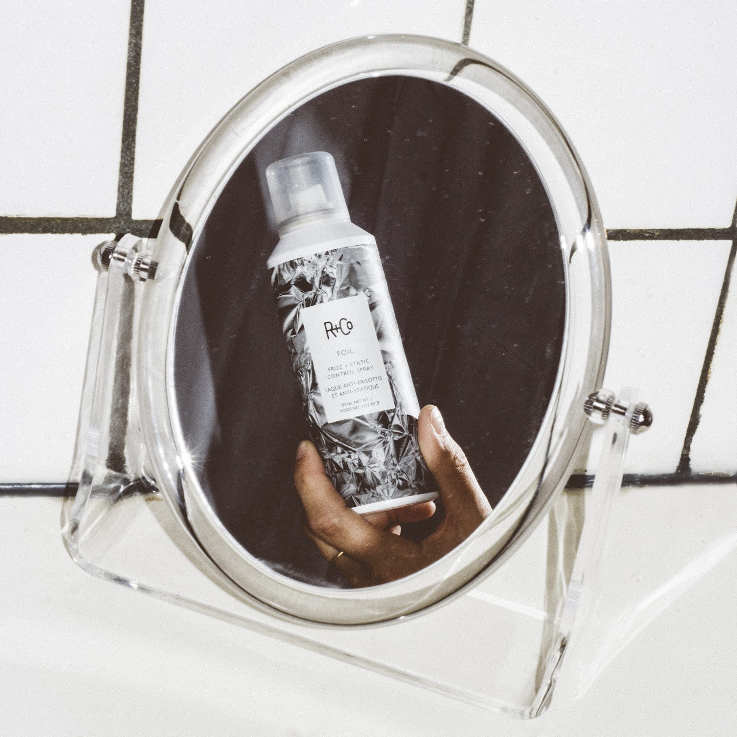 R+Co Foil Frizz Spray mist application showing quick, flexible control for shiny hair