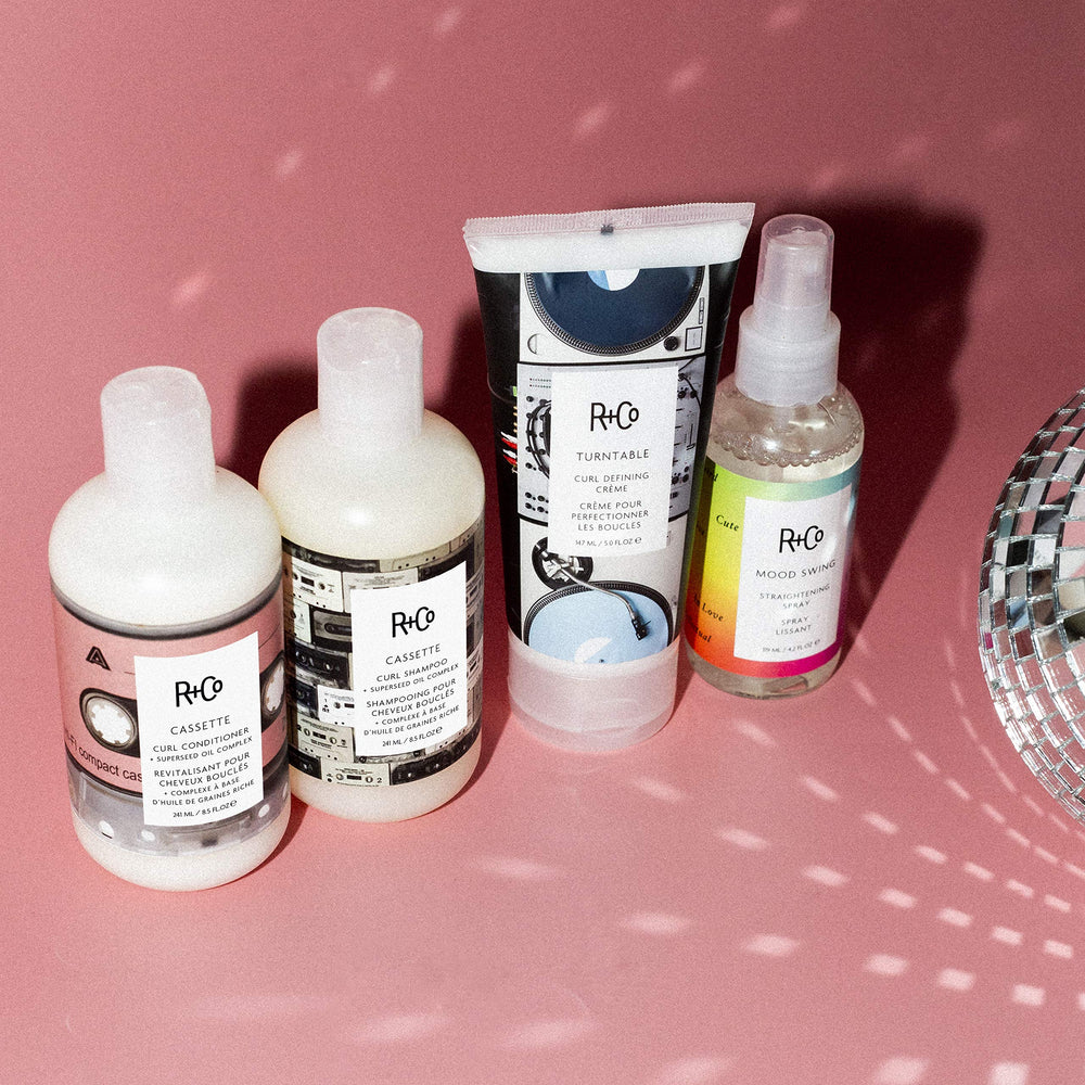 R+Co Mood Swing hair close-up highlighting shine and reinforced frizz control.