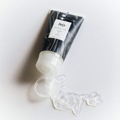 R+Co Motorcycle Flexible Gel in hand, ready to sculpt flexible styles with controlled shine.