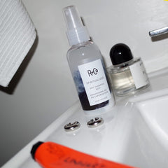 R+Co micellar formula close-up reveals suspended cleansing particles for light cleansing.