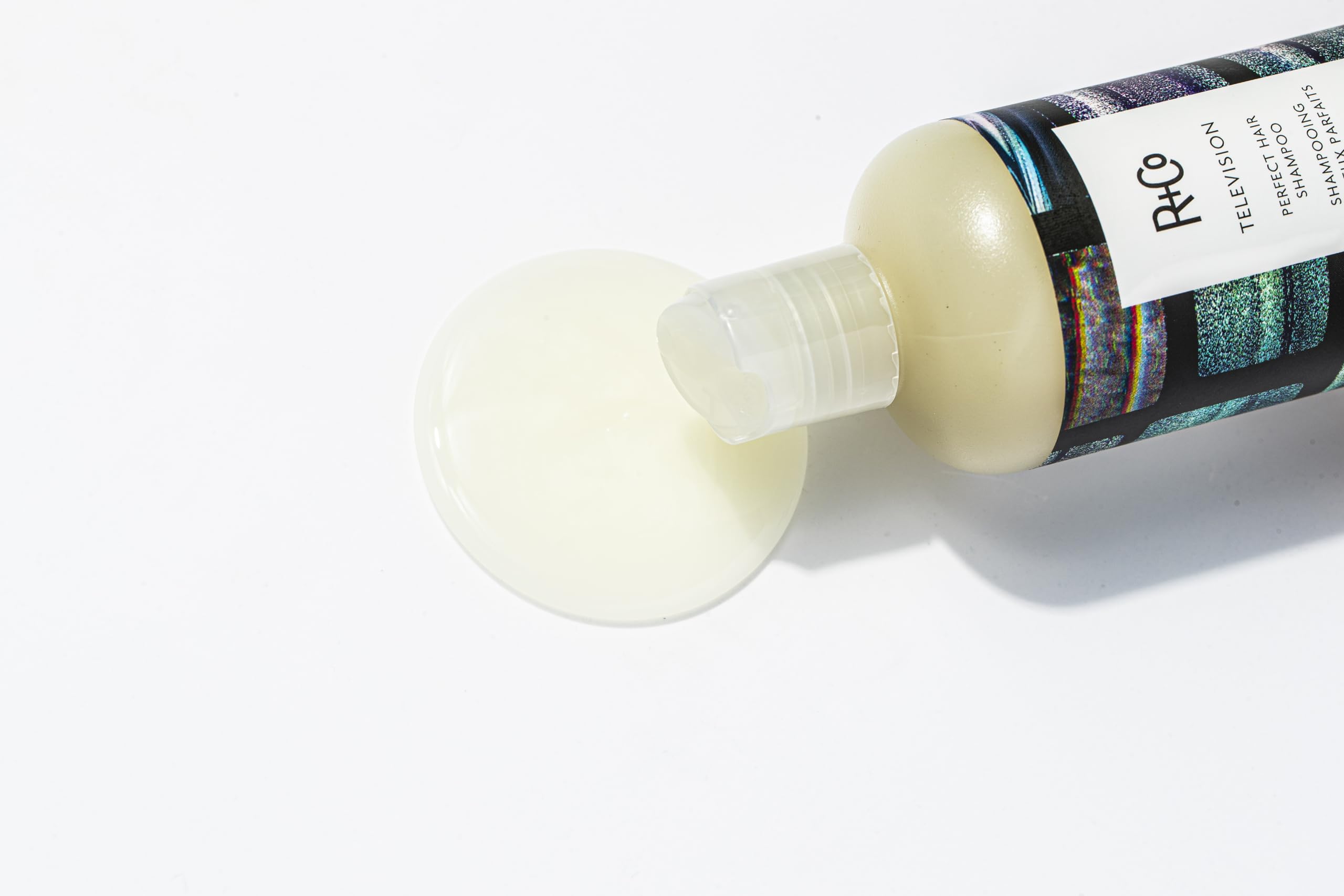 R+Co Television Perfect Hair Shampoo close-up emphasizes shine-enhancing softness.