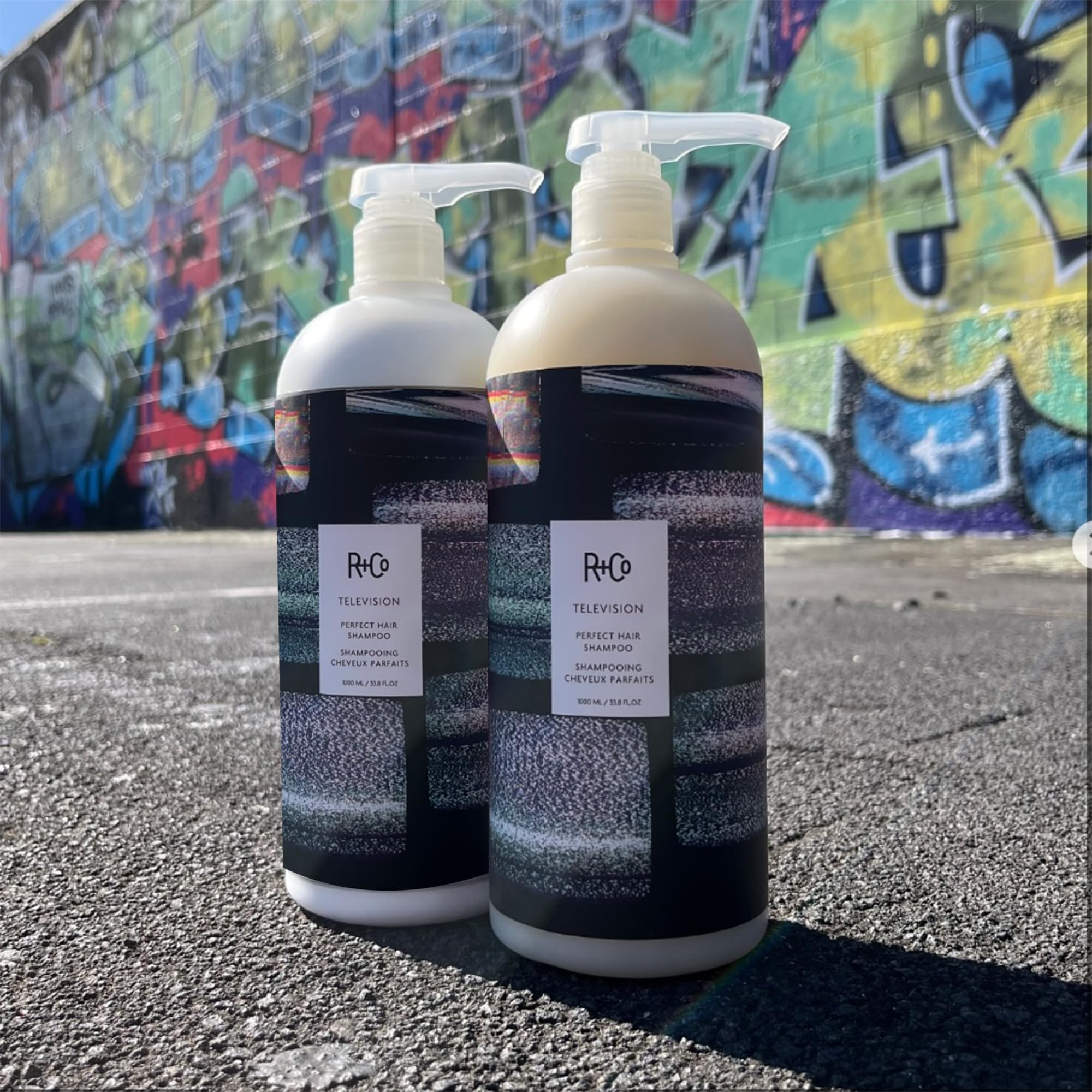R+Co Television Perfect Hair Shampoo on sink with clean styling area.