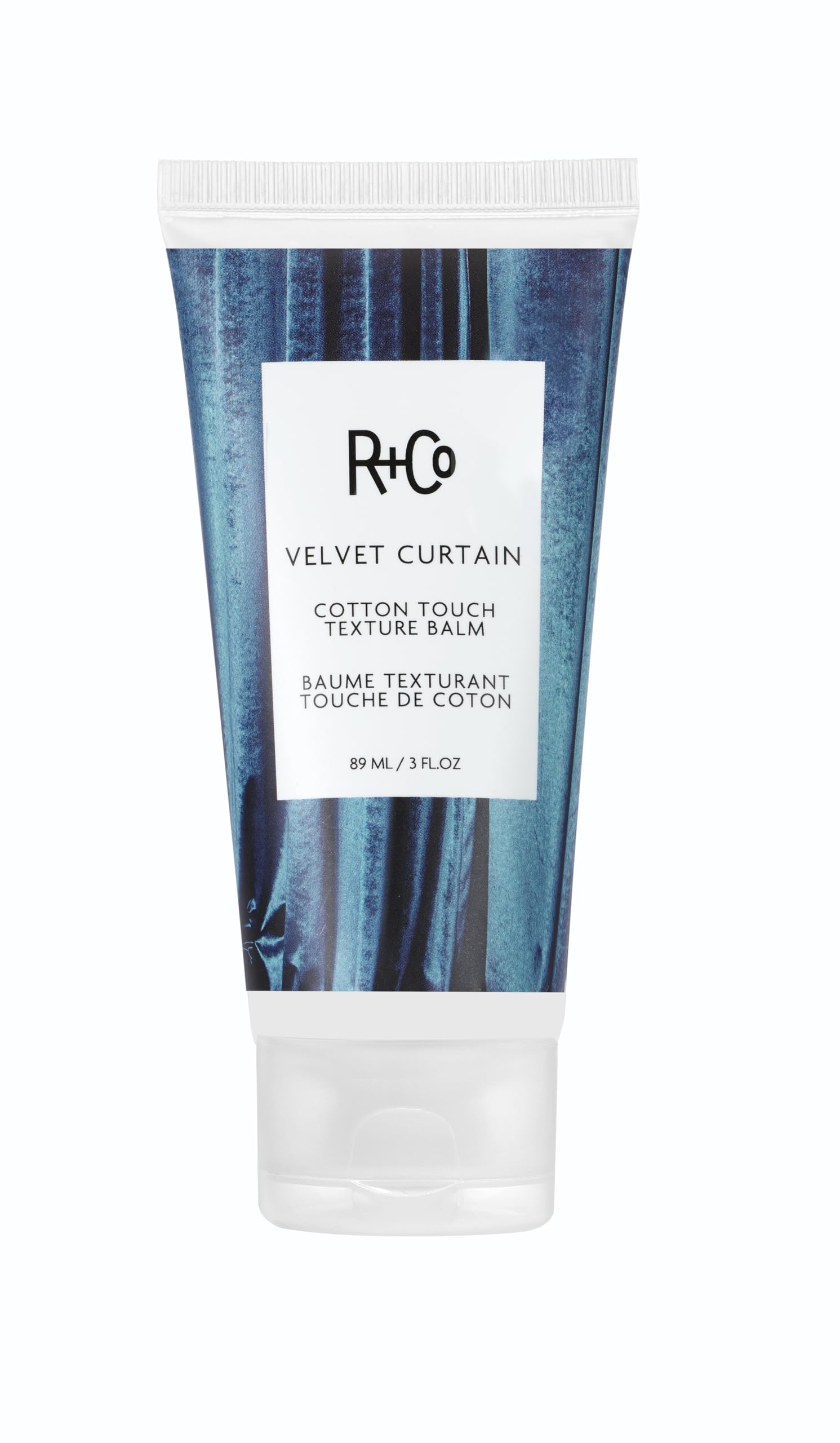 R+Co Velvet Curtain balm jar close-up, soft volume and light hold.