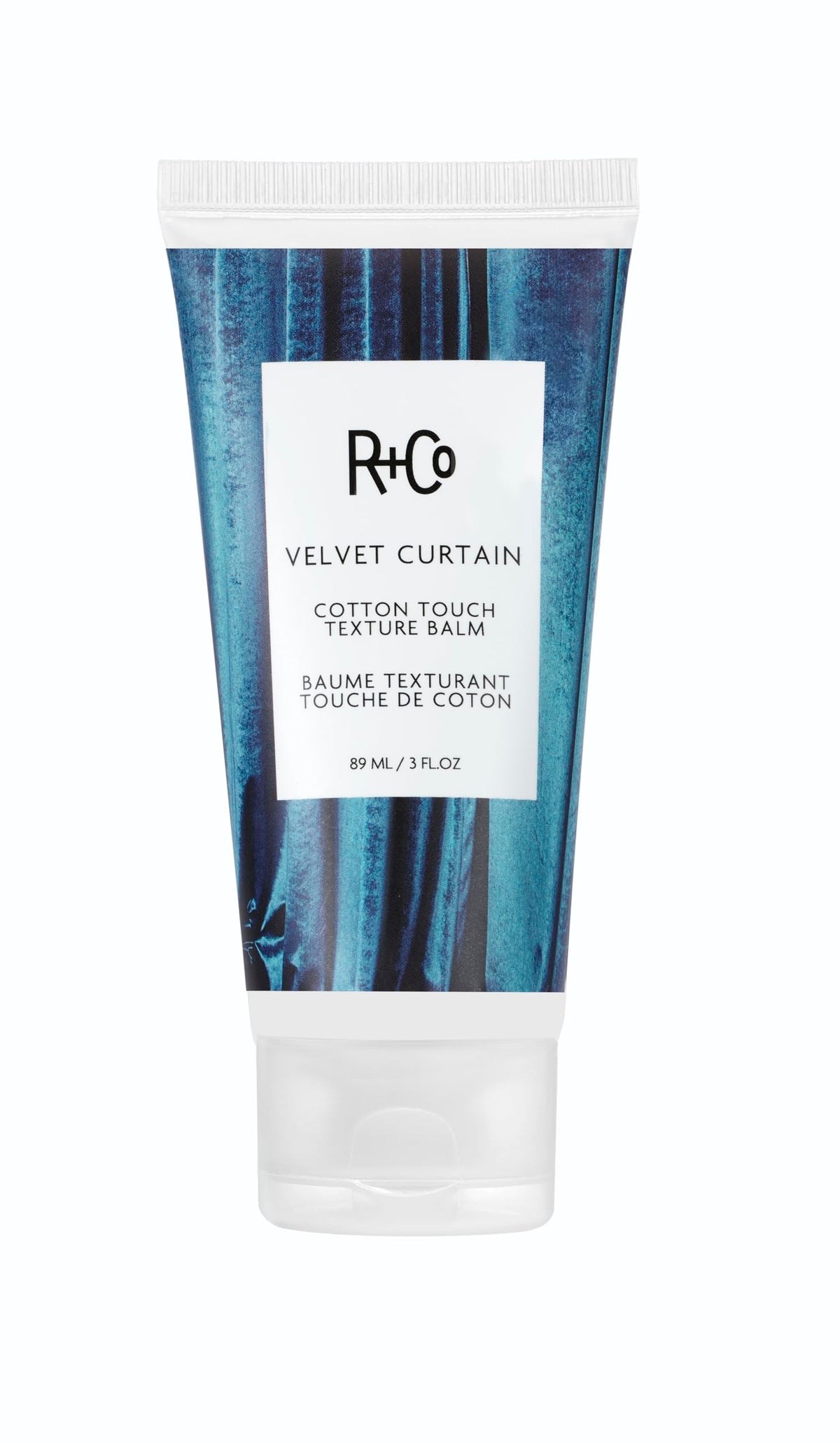 R+Co Velvet Curtain balm jar close-up, soft volume and light hold.