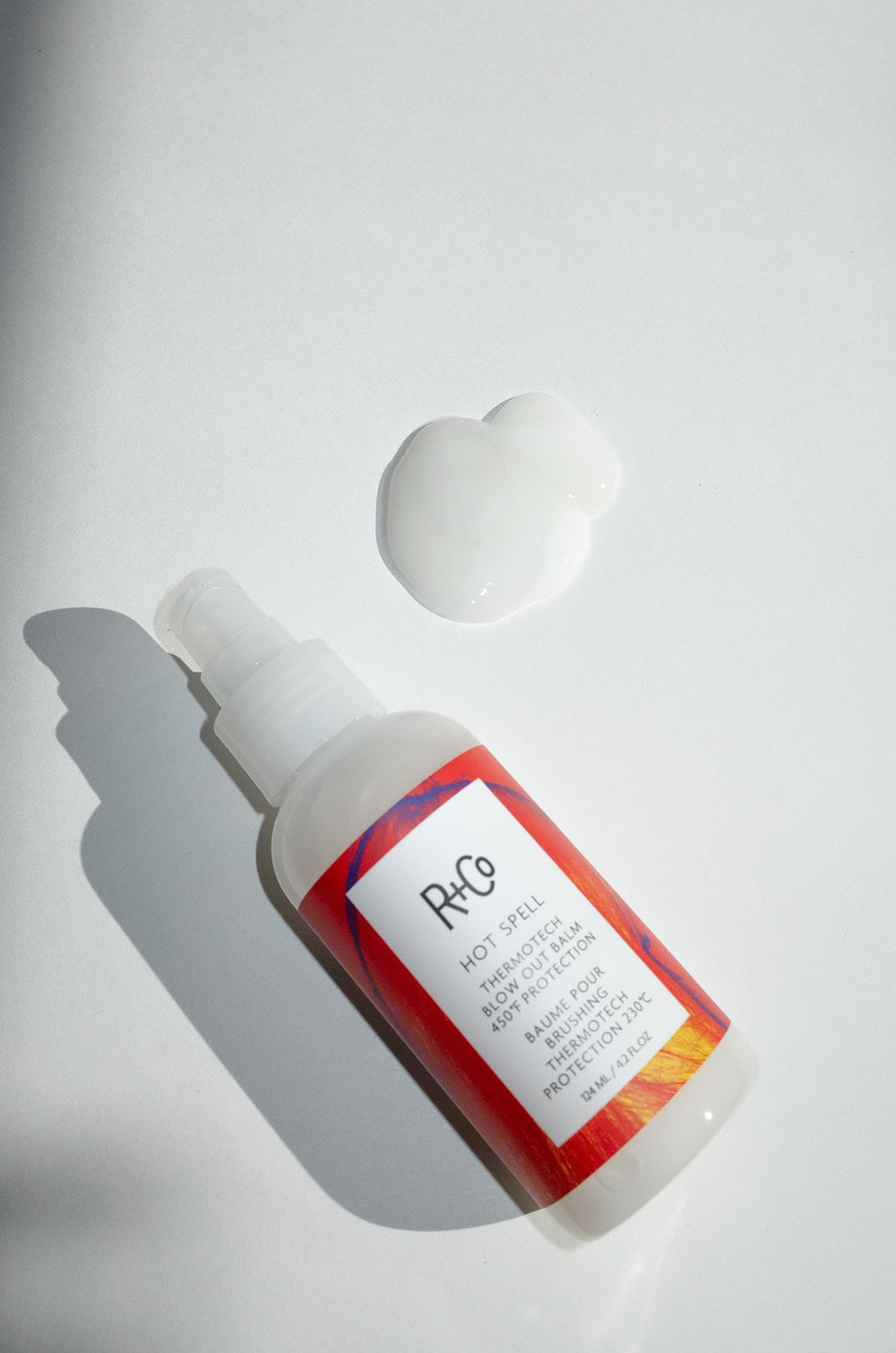 R+Co Hot Spell Thermotech Balm application shows smoothing balm ready for blowouts.
