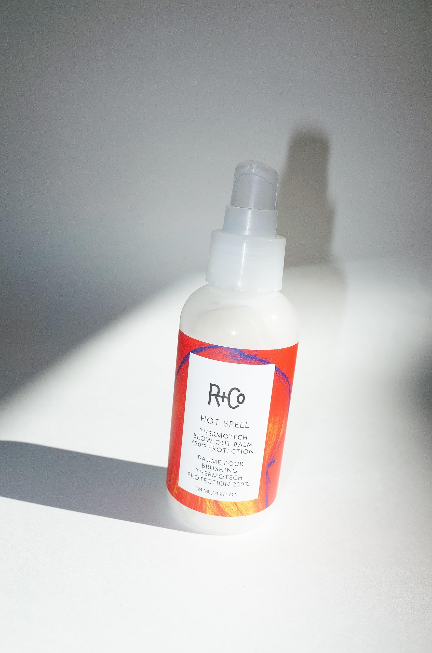 R+Co Hot Spell Thermotech Balm ingredient mustard-seed-oil closeup for frizz smoothing.