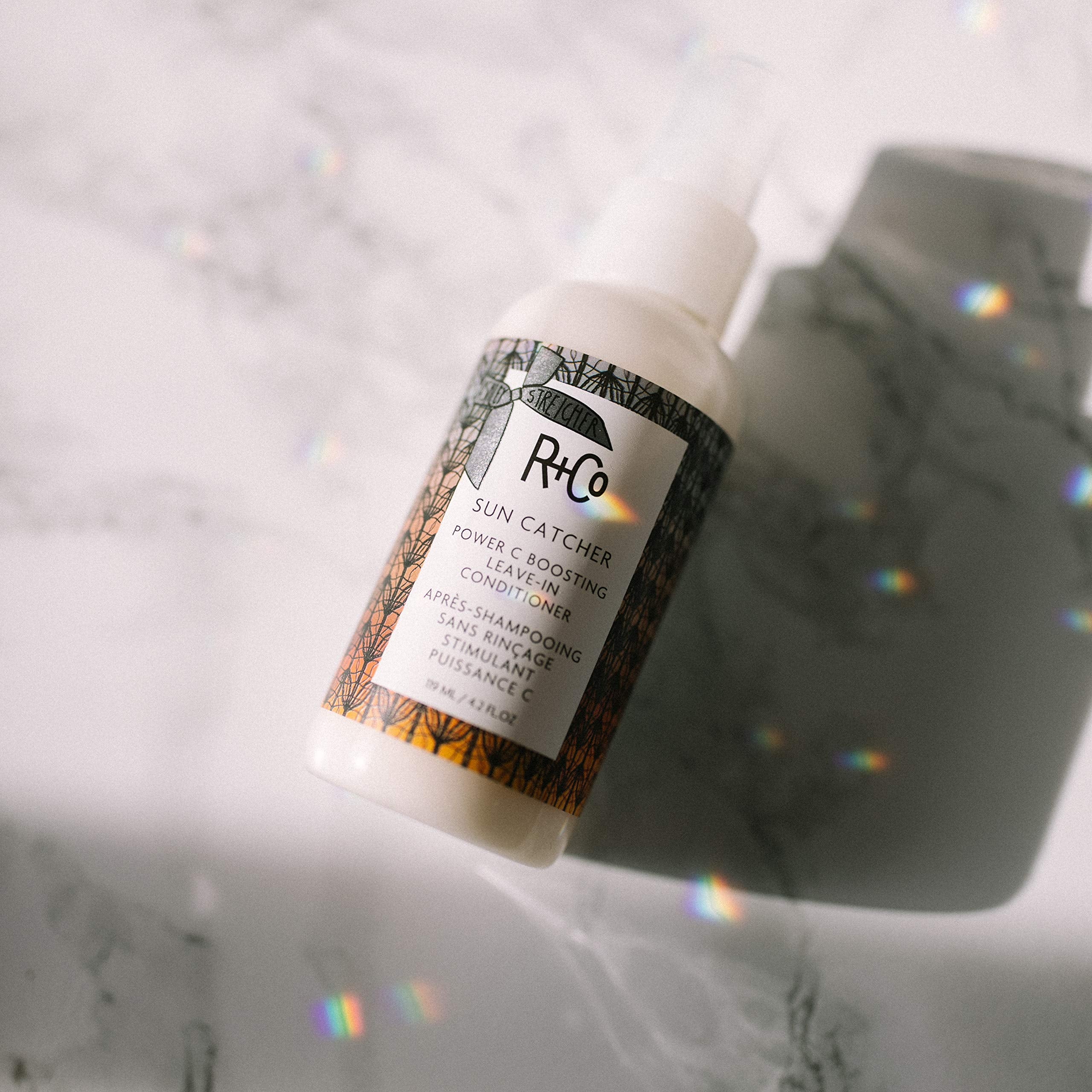 R+Co Sun Catcher Leave-In on damp hair for easier detangling