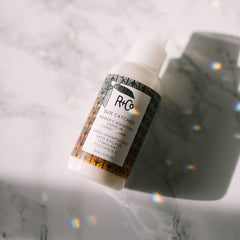 R+Co Sun Catcher Leave-In on damp hair for easier detangling
