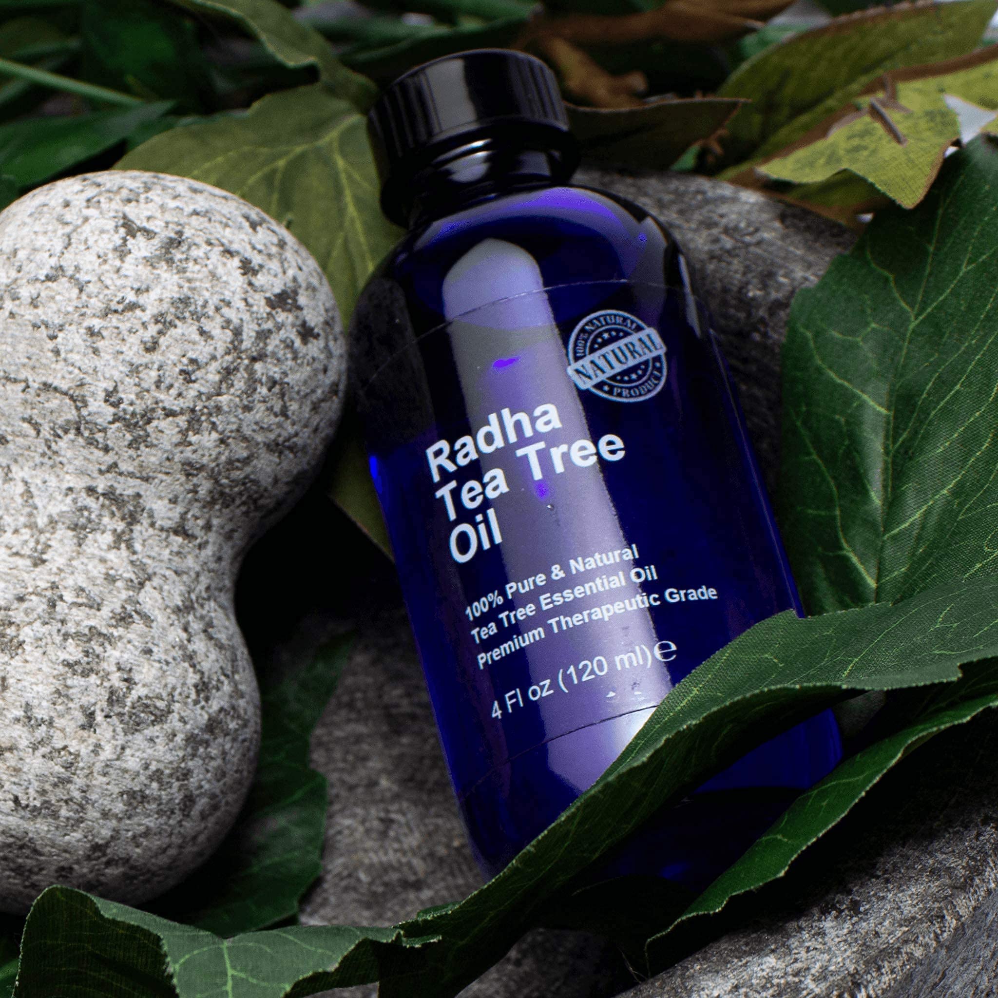 Radha Beauty Tea Tree Oil beside a diffuser setup for aromatherapy and air cleansing.