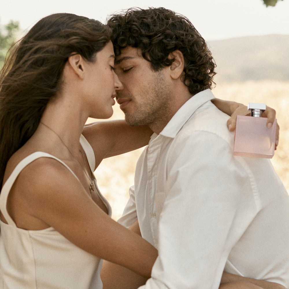 Lifestyle shot of Beyond Romance emphasizing rose-forward scent on warm skin