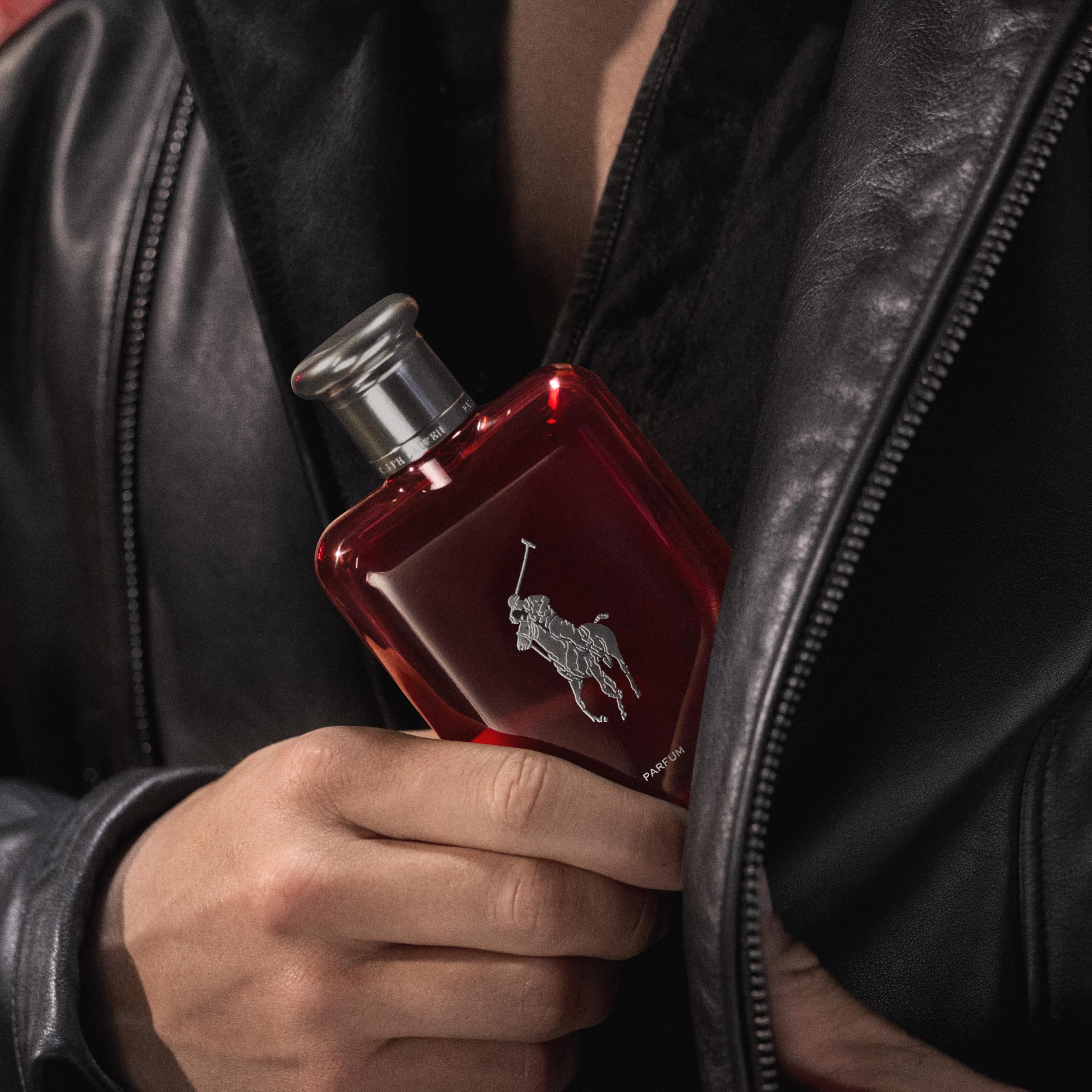 Absinthe-orris-cedarwood close-up hints at Polo Red Parfum's sensual amber-woody notes.