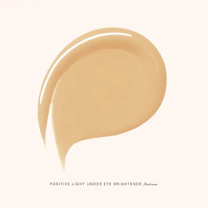 Rare Beauty under-eye brightener application demonstrates smooth glide for quick under-eye brightening