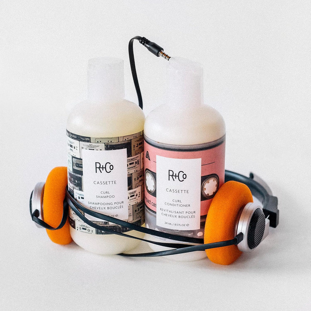 R+Co Cassette Curl Shampoo lather close-up emphasizing cleansing that preserves curls.
