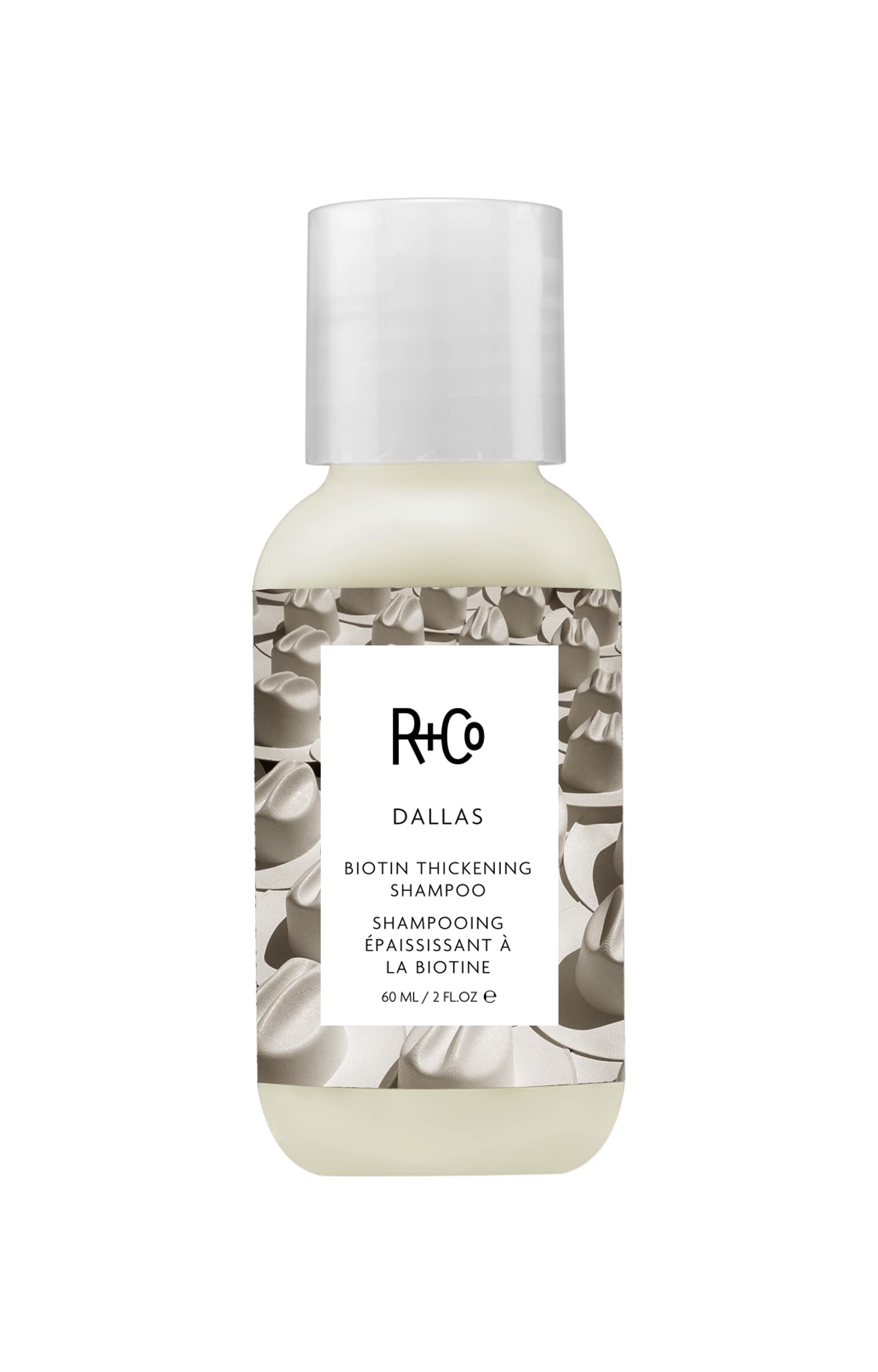 R+Co Dallas Thickening Shampoo bottle close-up for volumizing hair.