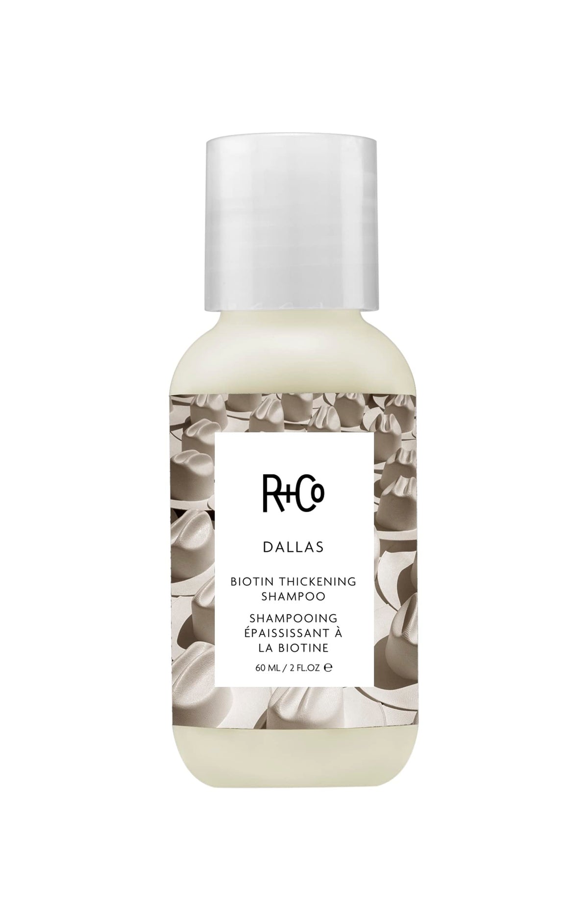 R+Co Dallas Thickening Shampoo bottle close-up for volumizing hair.