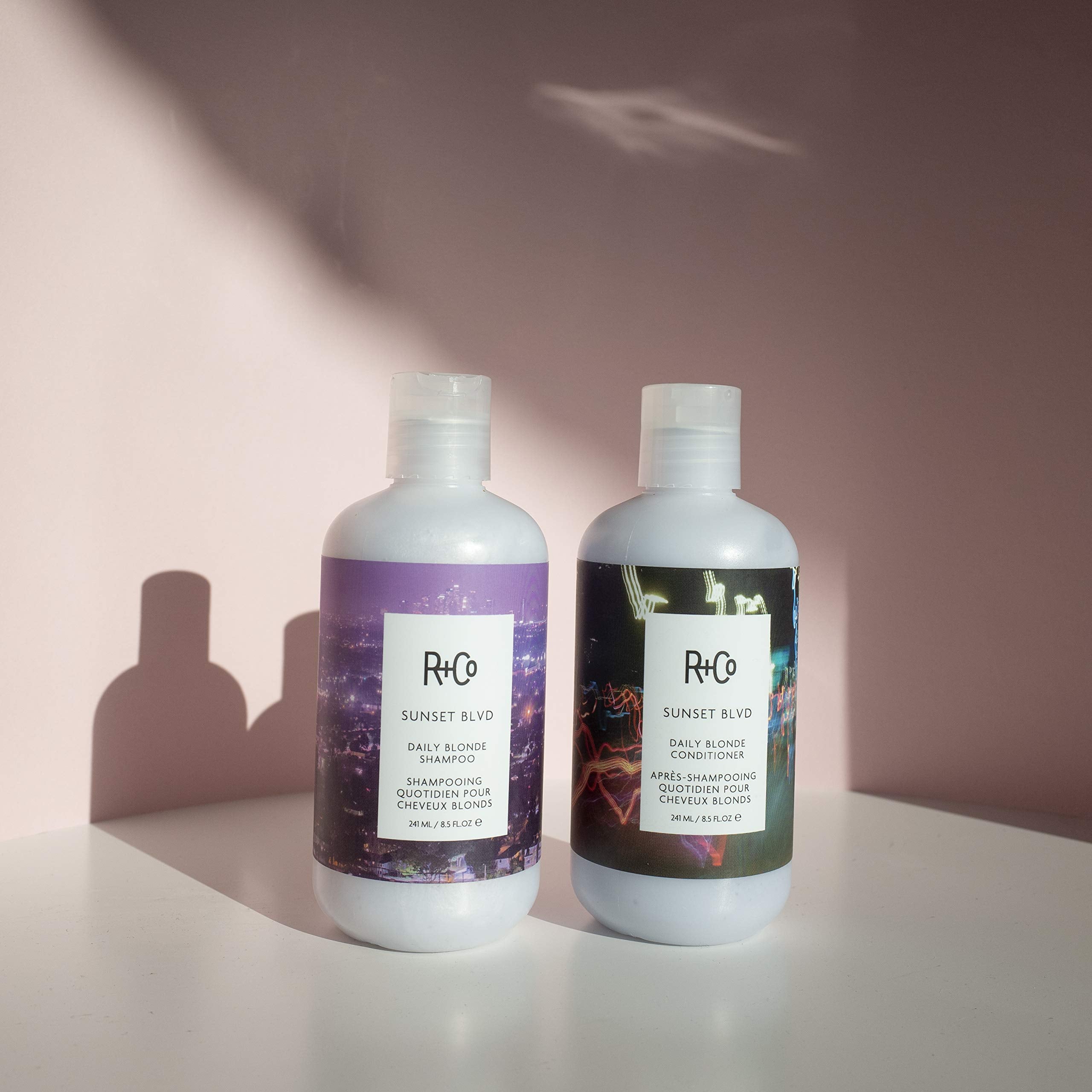 R+Co Sunset Blvd Conditioner creamy lather in hand, readying for smooth, nourished strands.