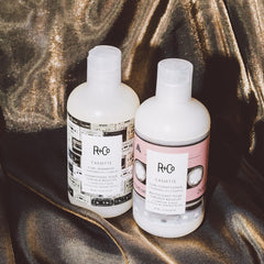 R+Co Superseed Oil Complex bottle close-up highlights moisture and nourishment.