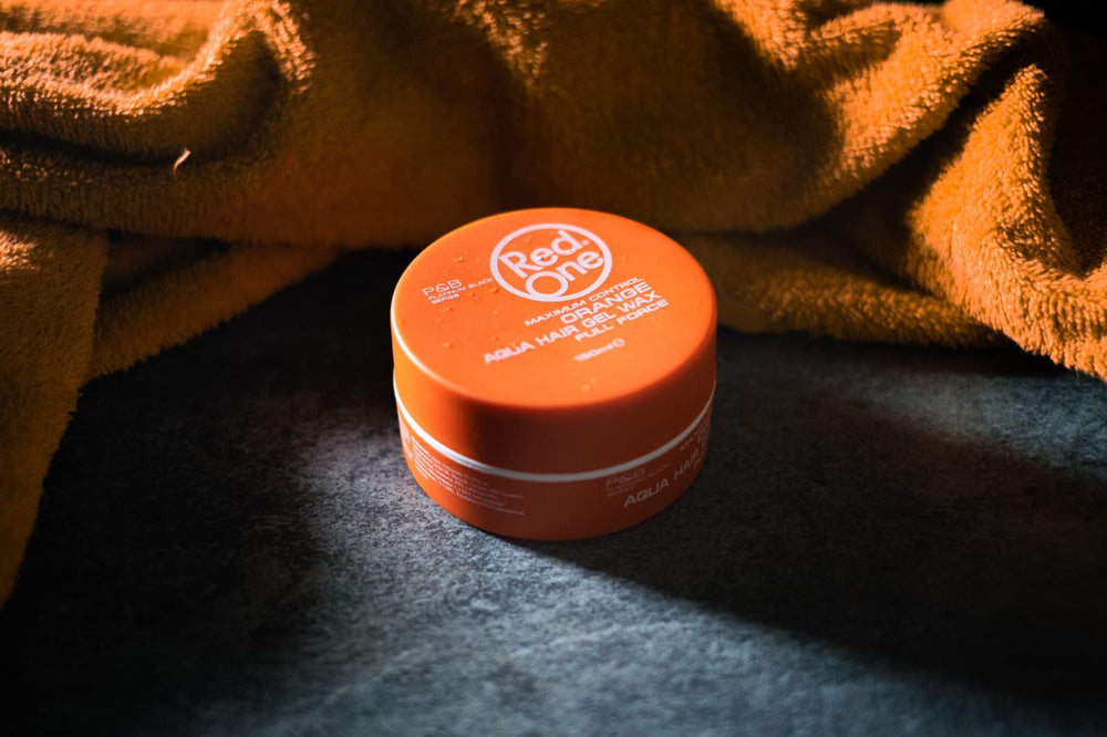 Redone Hair Wax Orange close-up highlights the refreshing melon scent.
