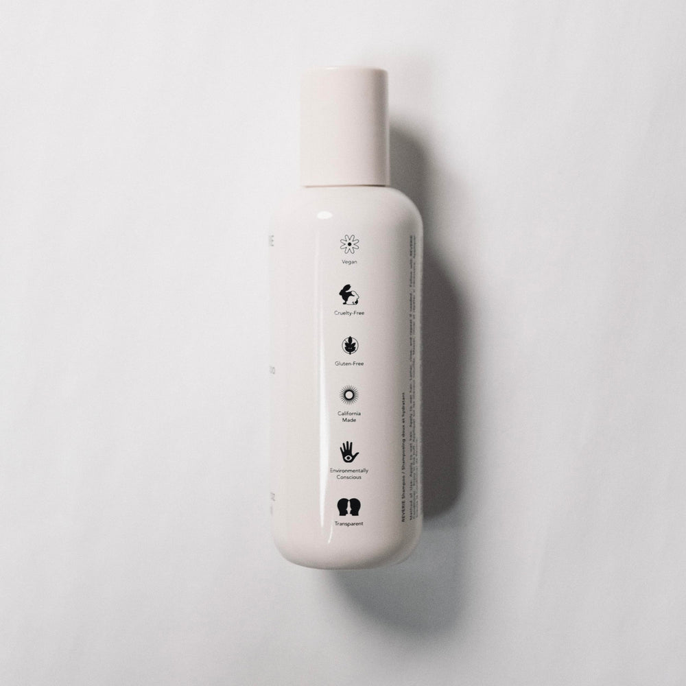 REVERIE Natural Balancing Shampoo lather on hand for gentle cleansing and hydration.