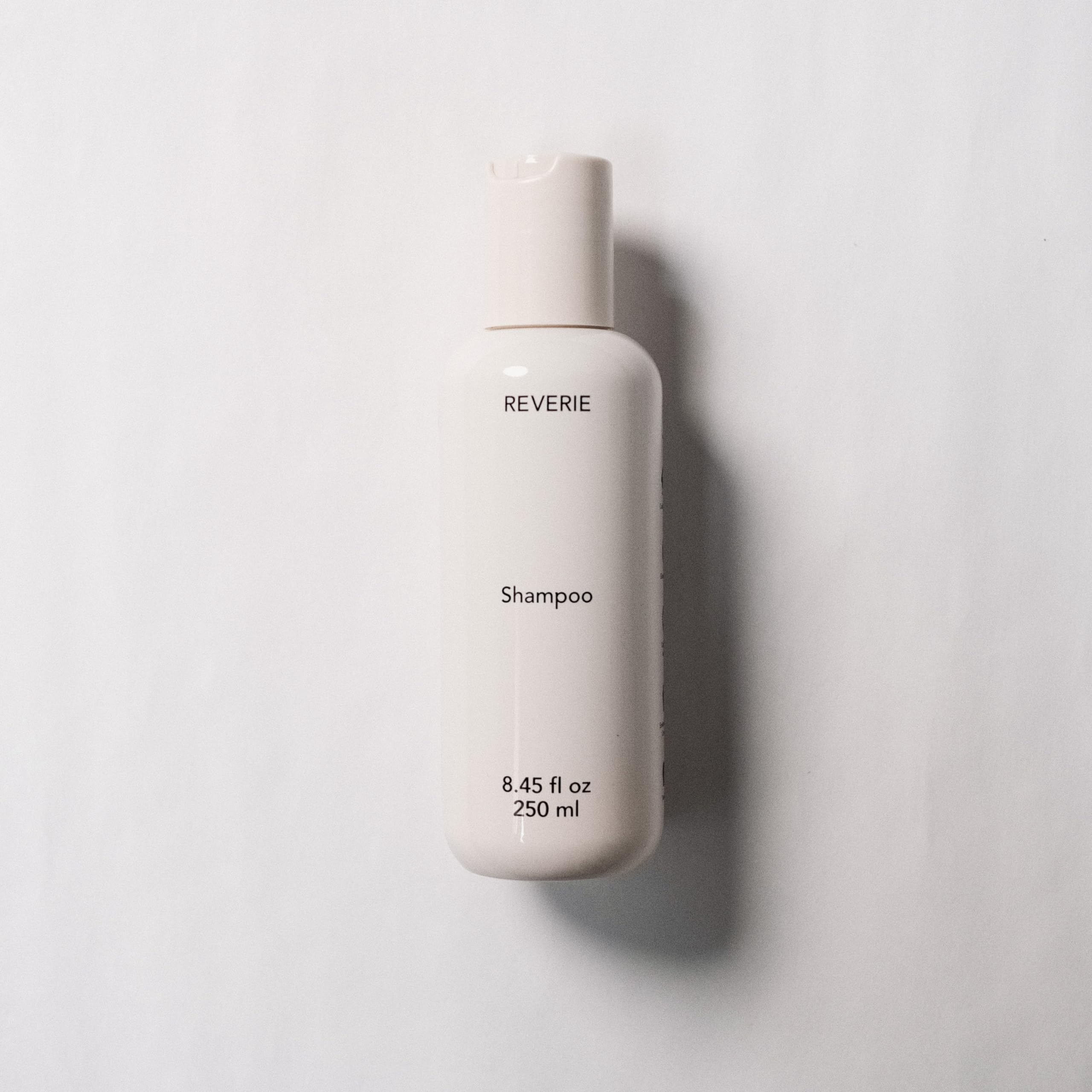 REVERIE Natural Balancing Shampoo pump-dispense top view for easy, controlled application.