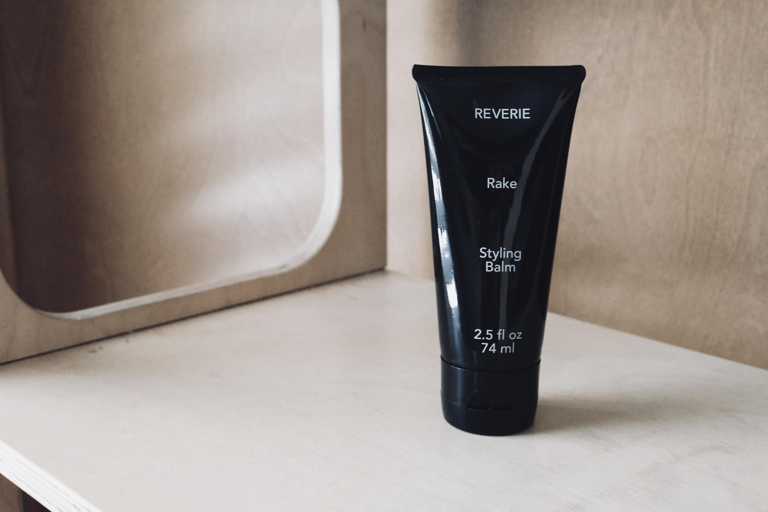 Full-size 2.5 oz REVERIE bottle on display for daily styling