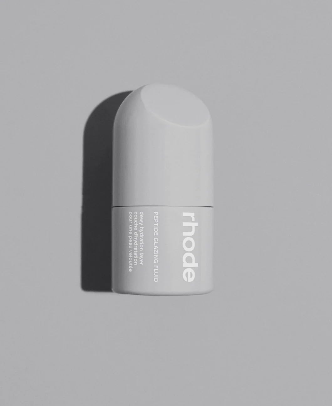 Rhode Hailey Bieber peptide glazing fluid bottle closeup reveals radiant hydration