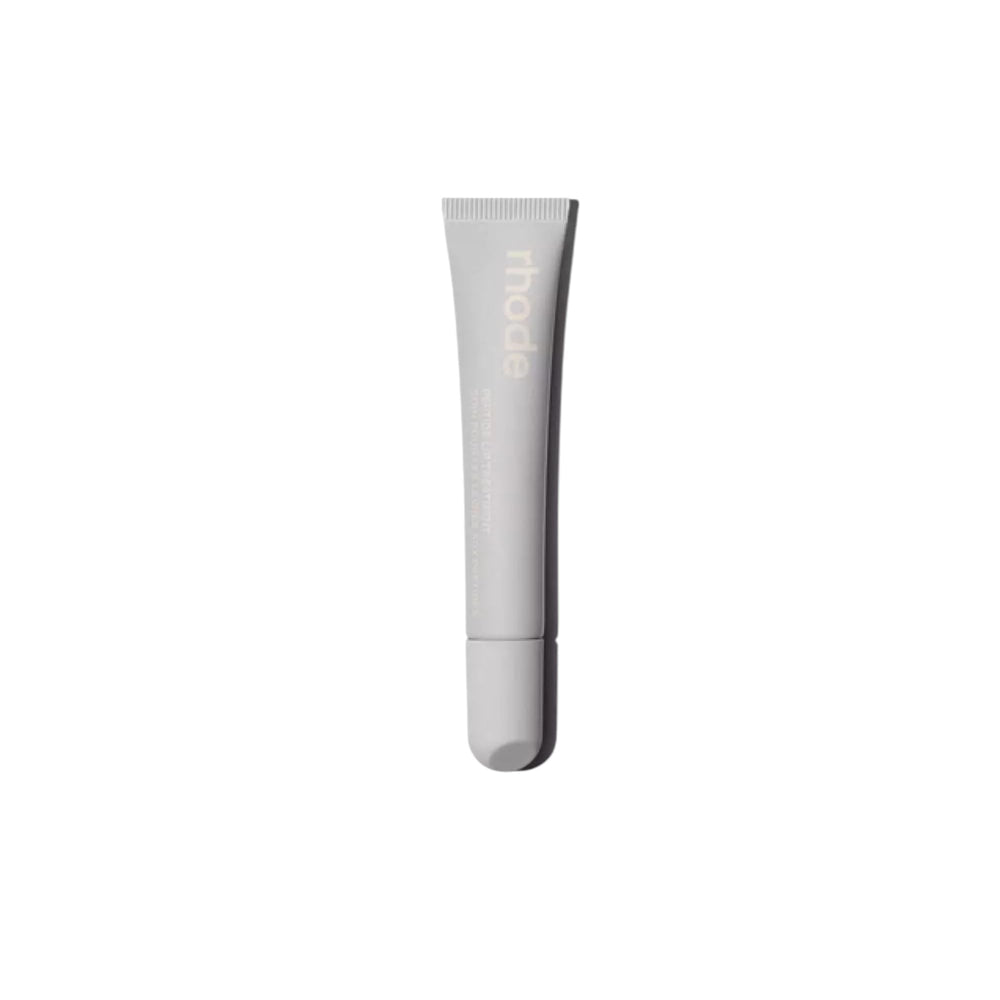 Rhode Salted Carmel Lip Treatment bottle closeup emphasizes glossy hydration.