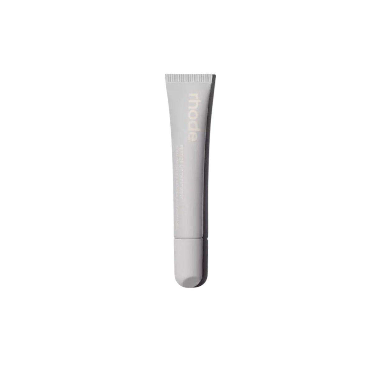Rhode Salted Carmel Lip Treatment bottle closeup emphasizes glossy hydration.