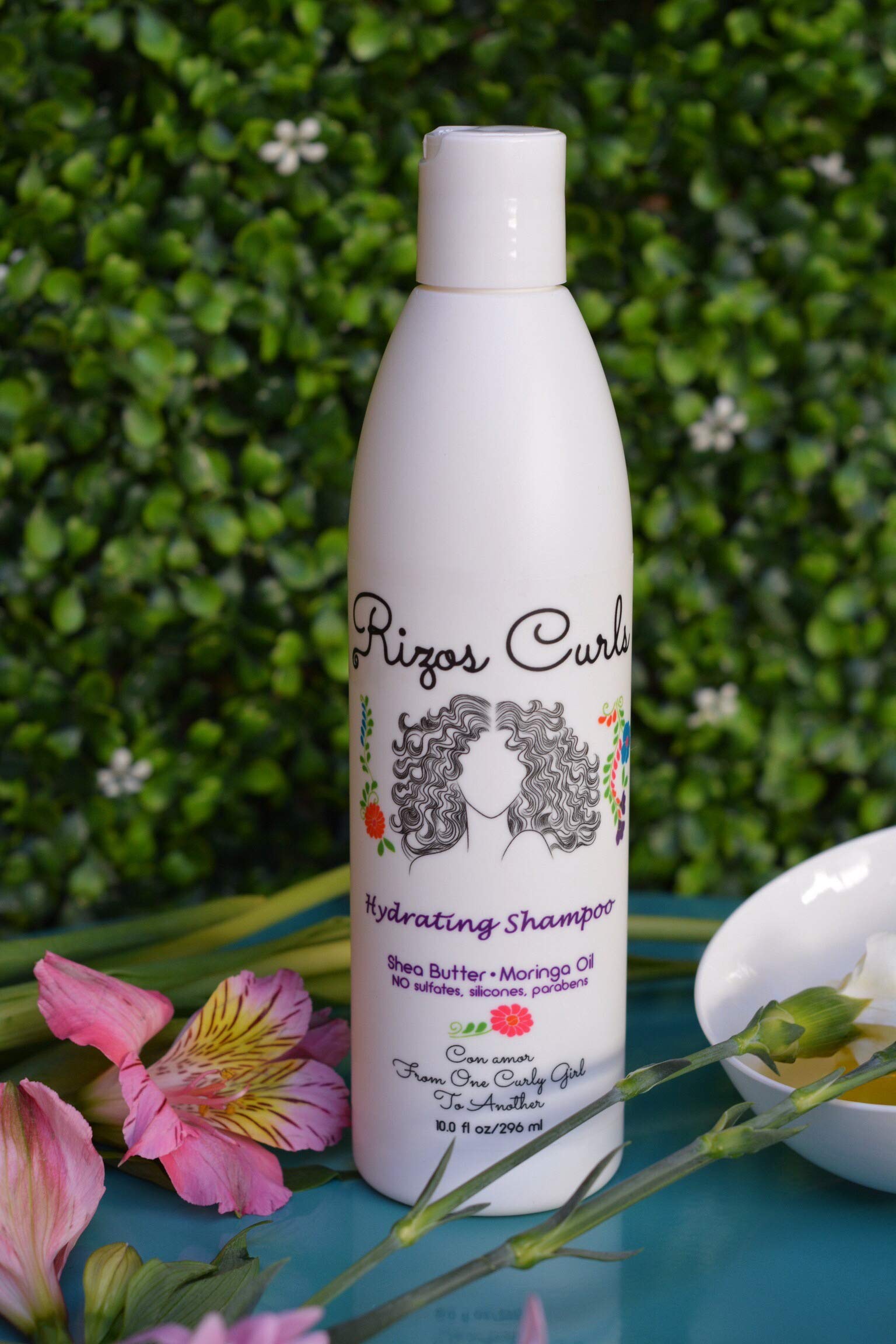 Rizos Curls Hydrating Shampoo pour bottle closeup shows a refreshing cleanse for curls.