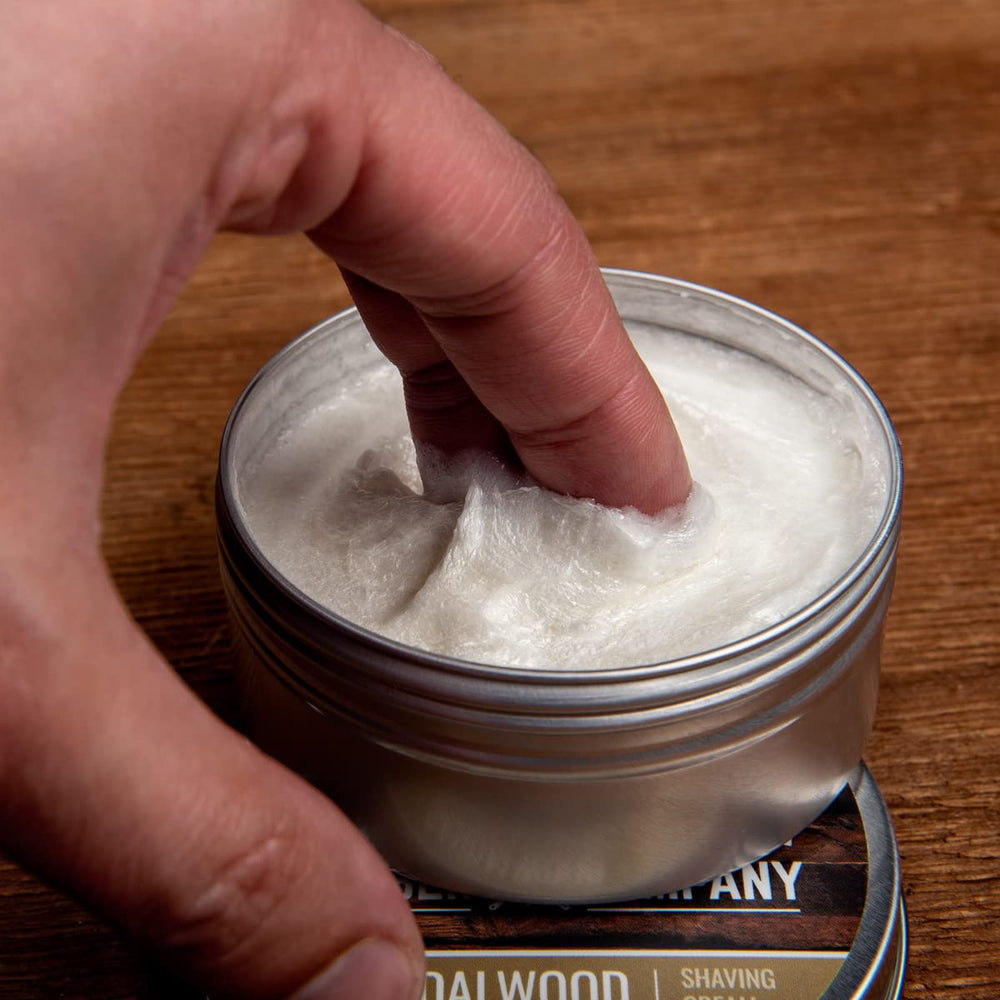 Rocky Mountain Barber Co open tin with creamy shaving cream.