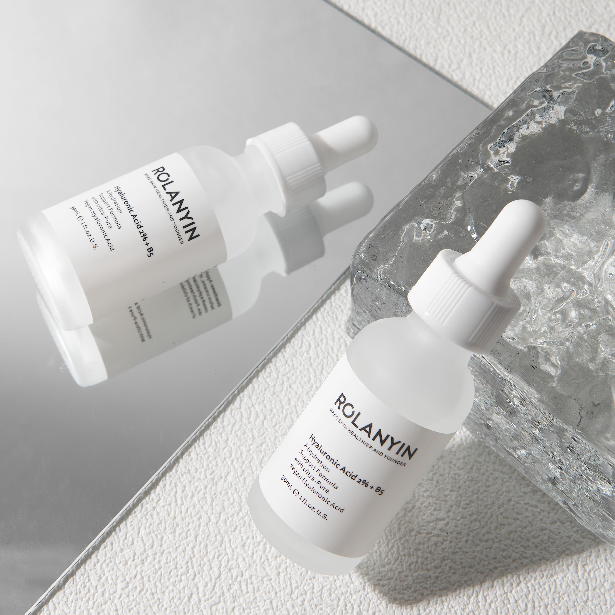ROLANYIN Hyaluronic Acid 2% + B5 Serum swirl on skin emphasizes smooth, hydrated texture.