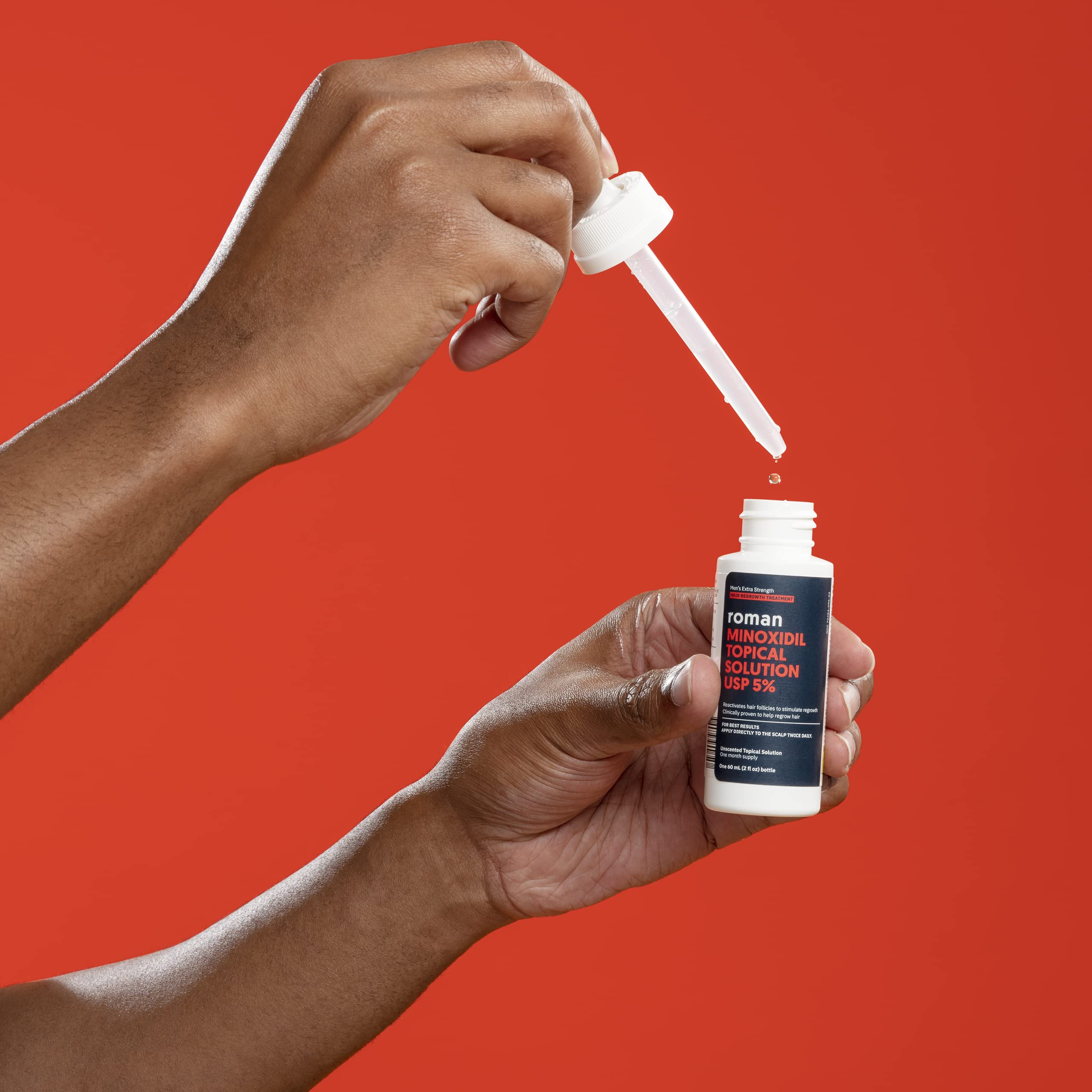 Roman Minoxidil being applied to thinning scalp area for targeted results