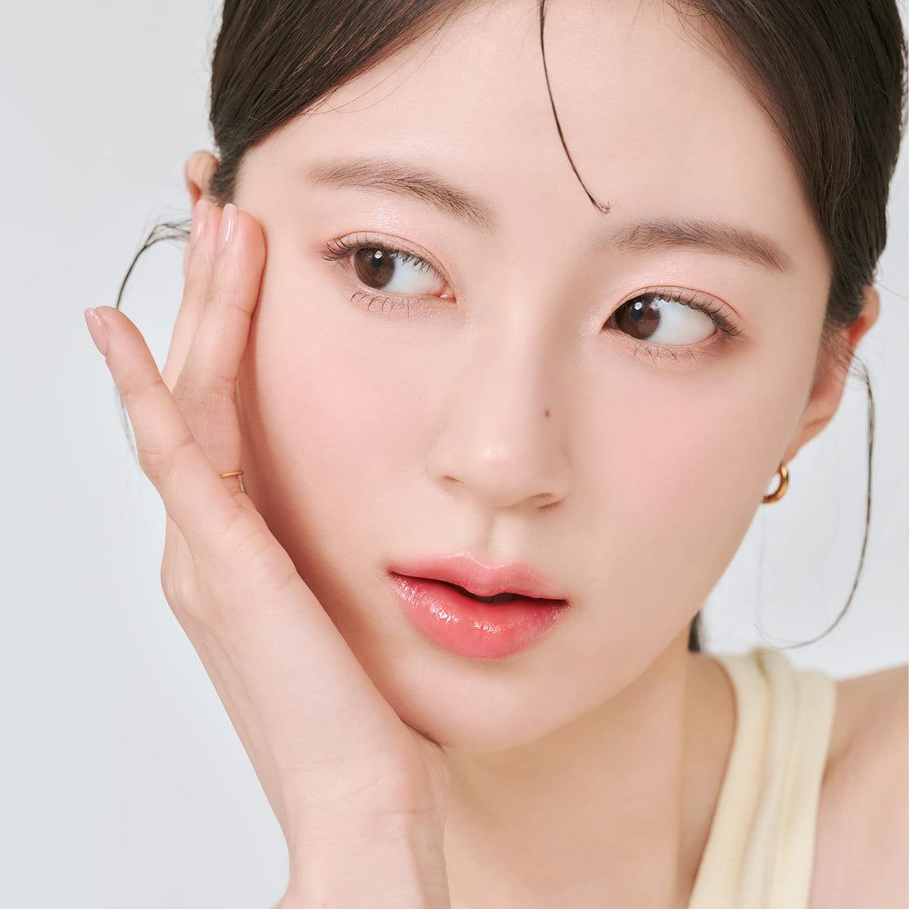 rom&nd Juicy Lasting Tint Bare Apricot glossy-finish close-up showcases smooth, non-sticky shine