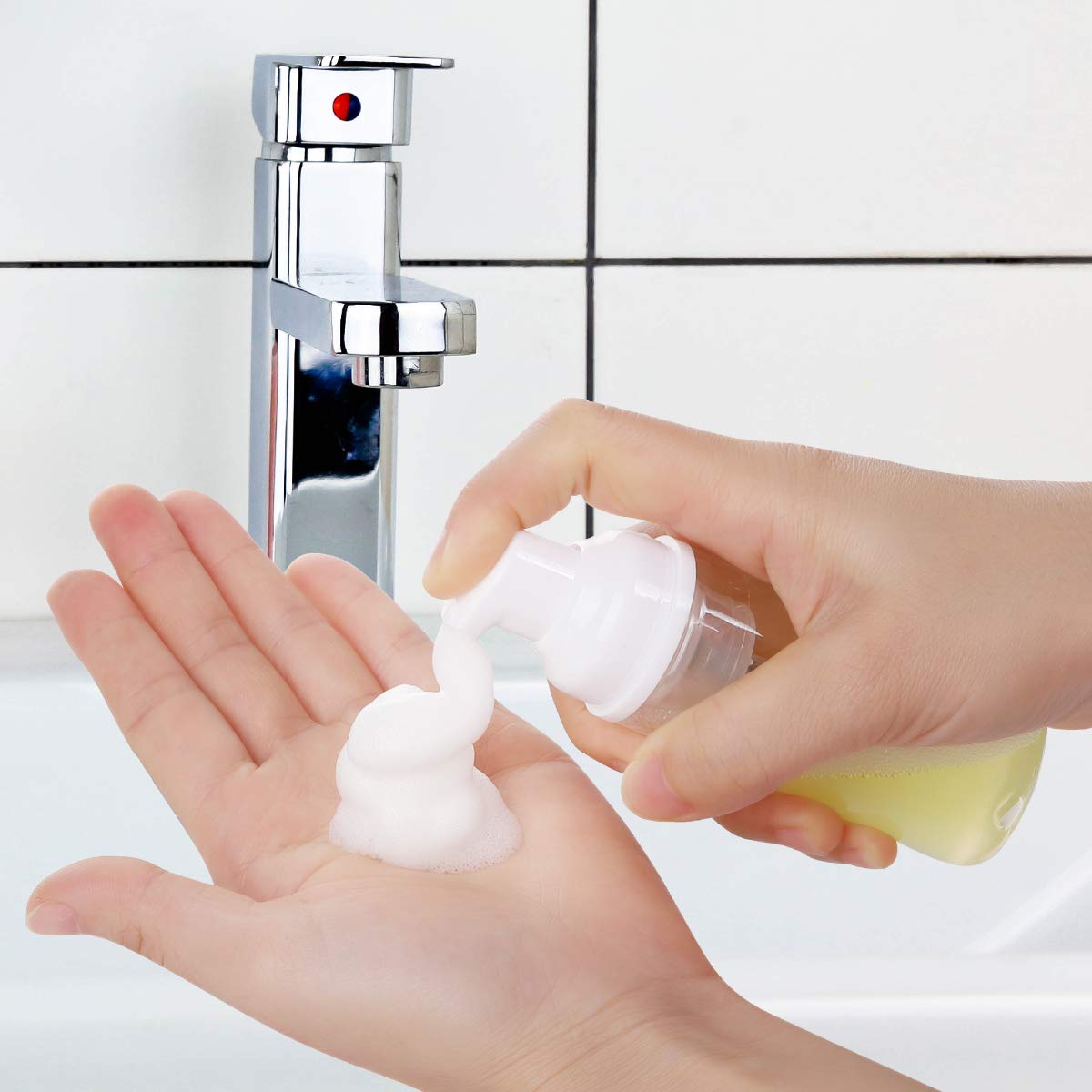 ROMROC hand holding foam bottle shows portable utility for travel or gym routines.