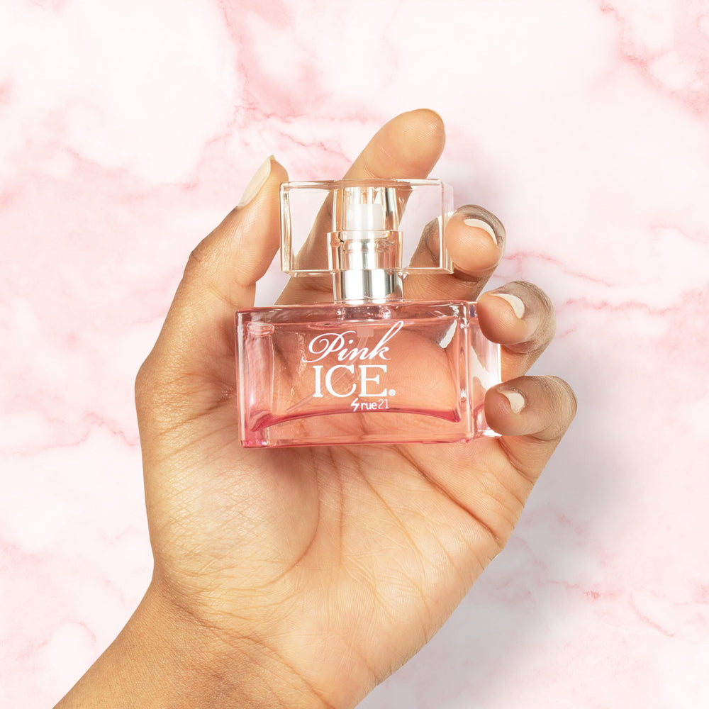 Rue 21 Pink Ice bottle being sprayed—compact travel-friendly perfume for on-the-go moments.