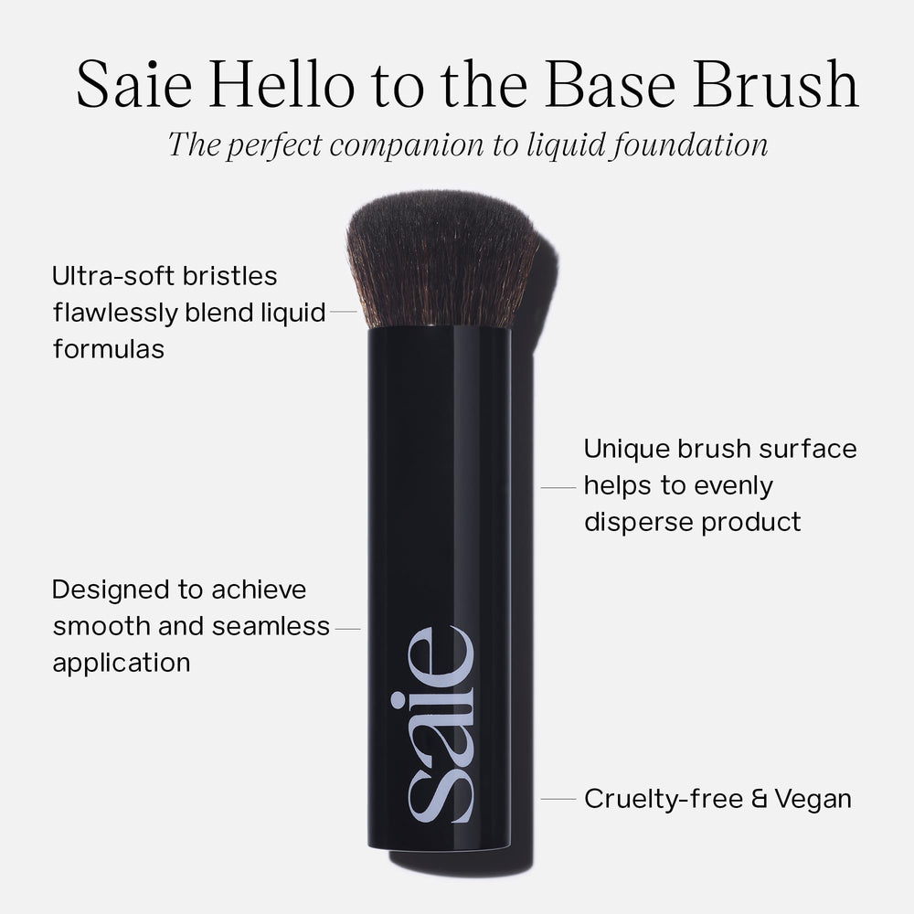Saie Base Foundation Brush flat-top in use for seamless skin tint blending.