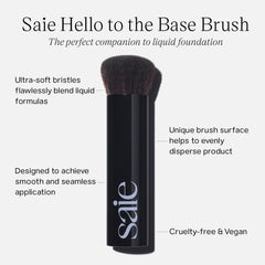 Saie Base Foundation Brush flat-top in use for seamless skin tint blending.