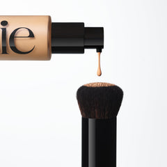 Saie Base Foundation Brush paired with Glowy Skin Tint for even, natural-looking coverage.