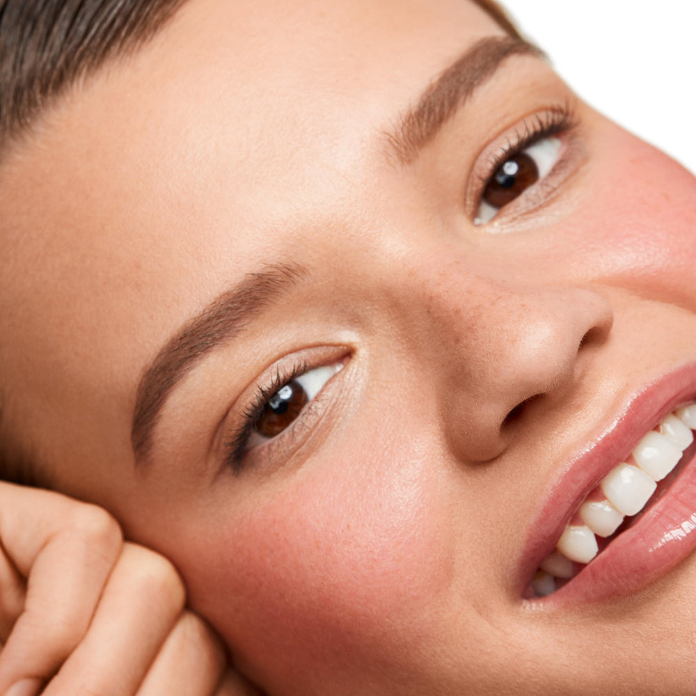 Saie Dew Liquid Blush on cheek shows dewy glow