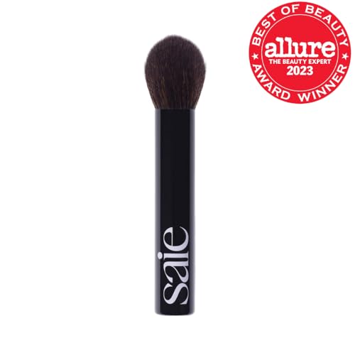 Saie The Fluffy Brush tapered tip highlights precision for targeted powder application.
