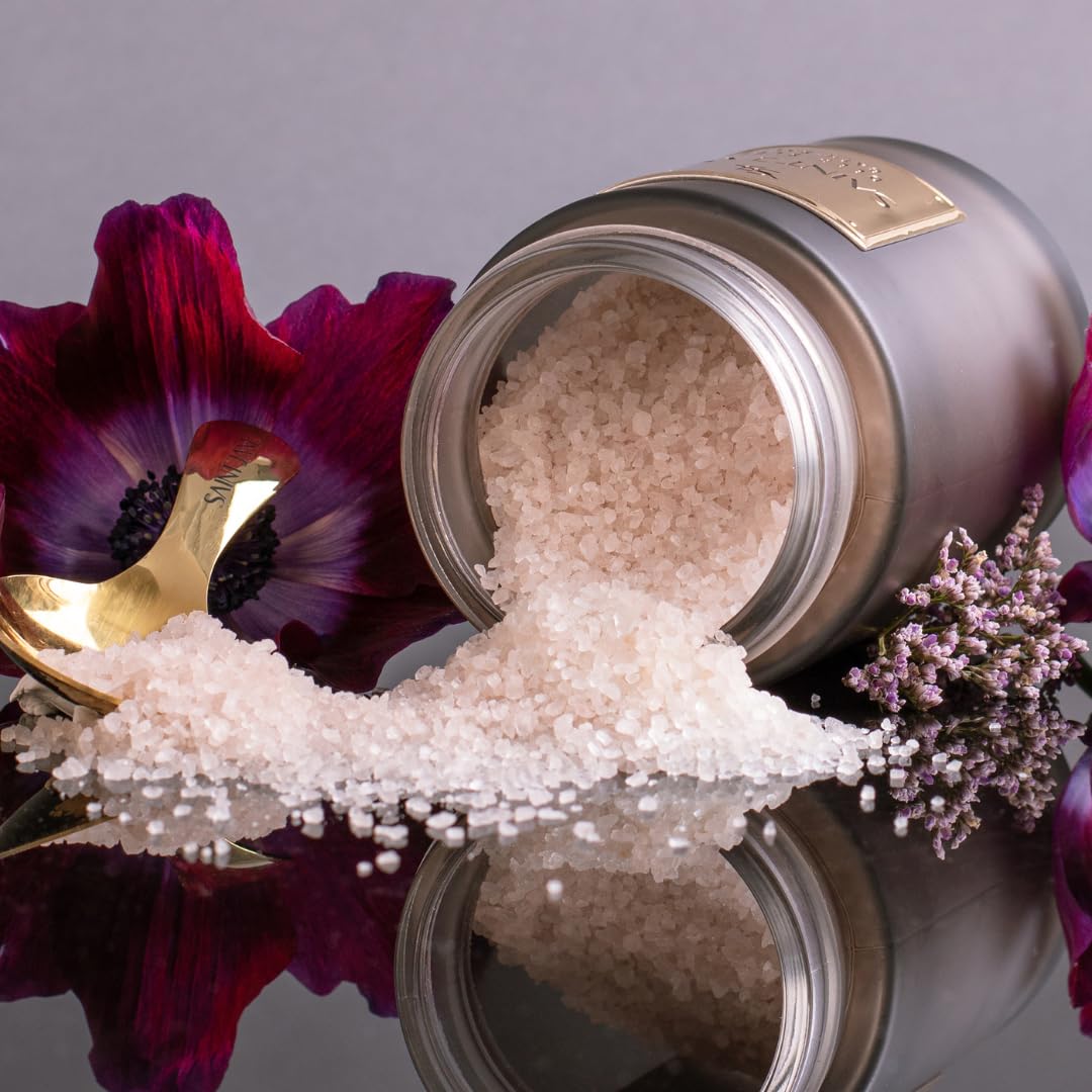 SAINT JANE Deep Sleep Bath Salts in a serene bath setting with petals for luxurious unwind.