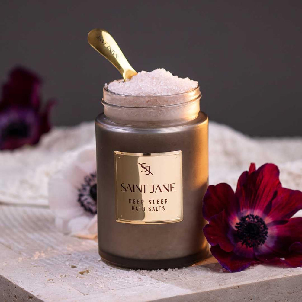 SAINT JANE Deep Sleep Bath Salts with florals in a spa-like scene for calm ritual.
