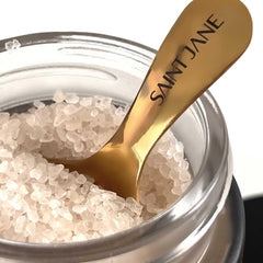 SAINT JANE Deep Sleep Bath Salts jar closeup shows magnesium-rich crystals for relaxation.