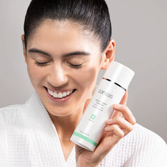 Sanitas Lemon Cream Cleanser ingredients closeup highlights vitamin C and jojoba oil.