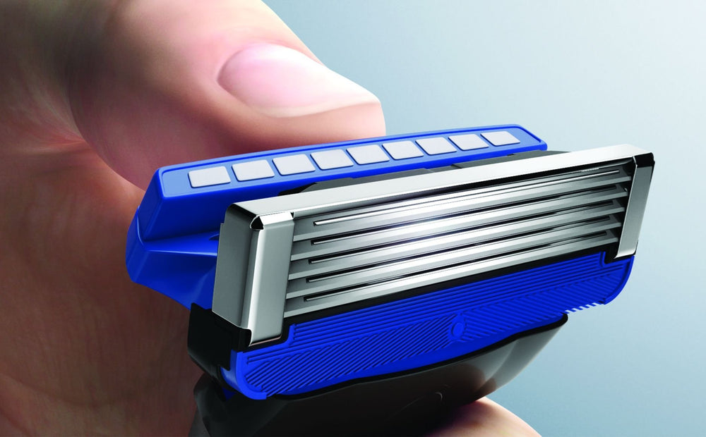 Schick Hydro 5 refill close-up highlights five blades and irritation protection.