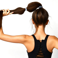 Scunci Evolution hair ties around a ponytail demonstrate discreet, versatile styling.