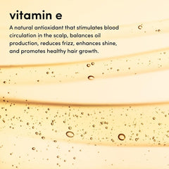 SEVEN Gazar Diamond Serum application on hands demonstrates smoothing action on frizzy hair.