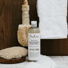 Creamy SheaMoisture foam massaging skin for softness during shower.